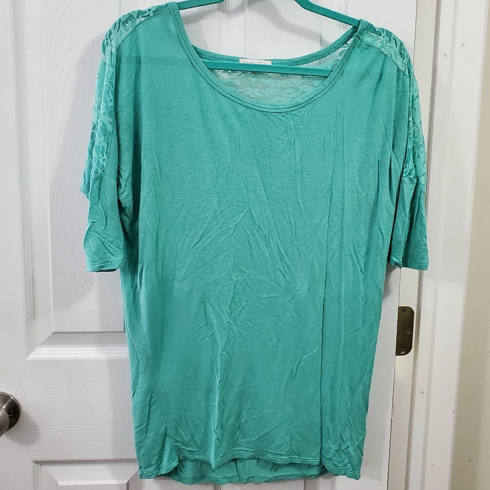 Turquoise blouse with lace detail.
